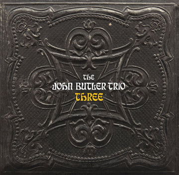 Vinyl record cover for the album 'THREE' by The John Butler Trio featuring an embossed design with the band's name.