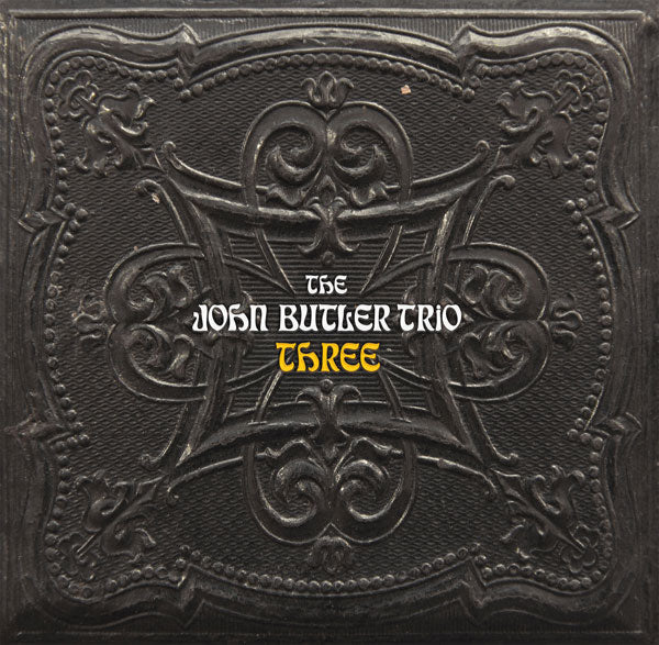 Vinyl record cover for the album 'THREE' by The John Butler Trio featuring an embossed design with the band's name.
